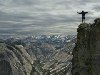 Background:  Man Worshipping on Cliff